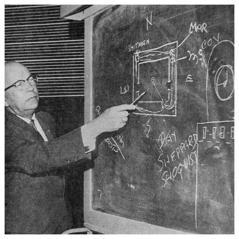 Police Chief Bob Miles pointing to a chalkboard diagram of the tower deck, with Martinez marked on the front line